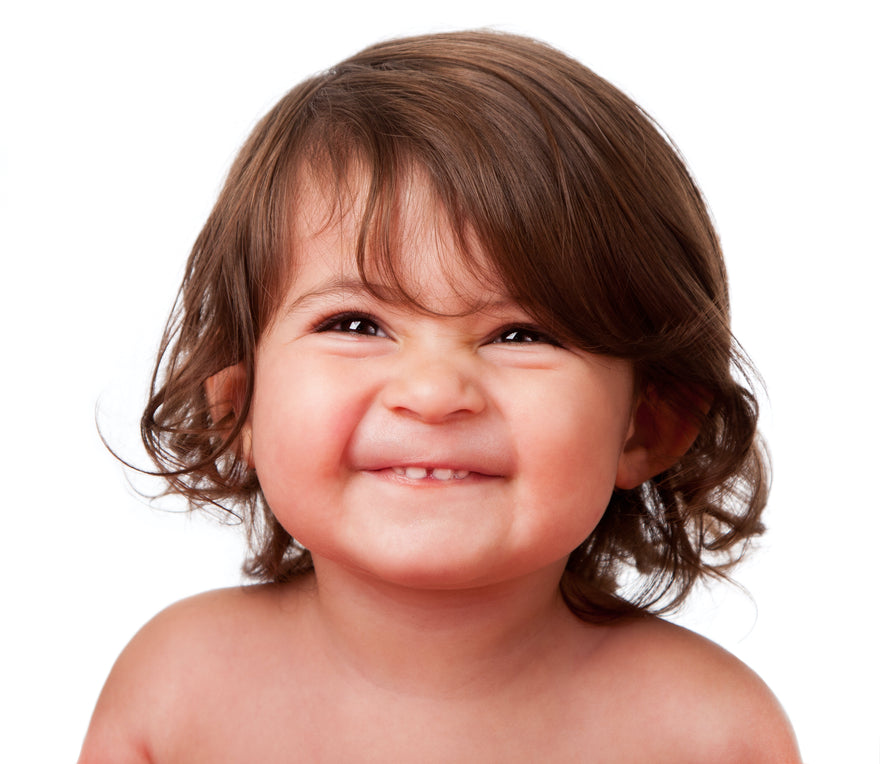 Grinning curly haired toddler