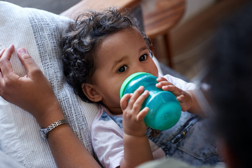 Toddler drinking milk from sippy cup