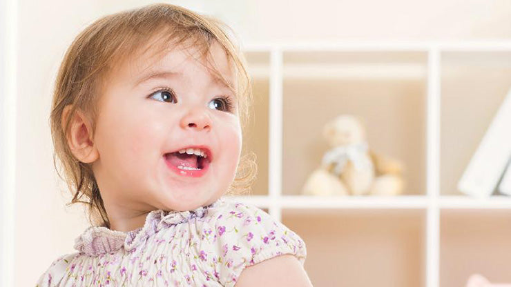 Happy toddler smiling at the camera