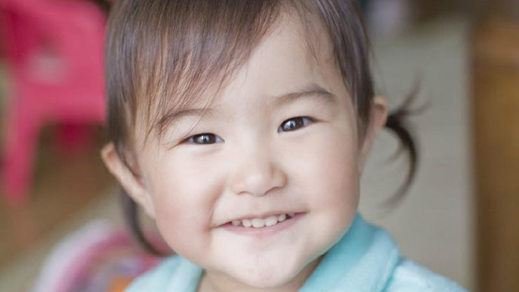 Grinning toddler looking at camera