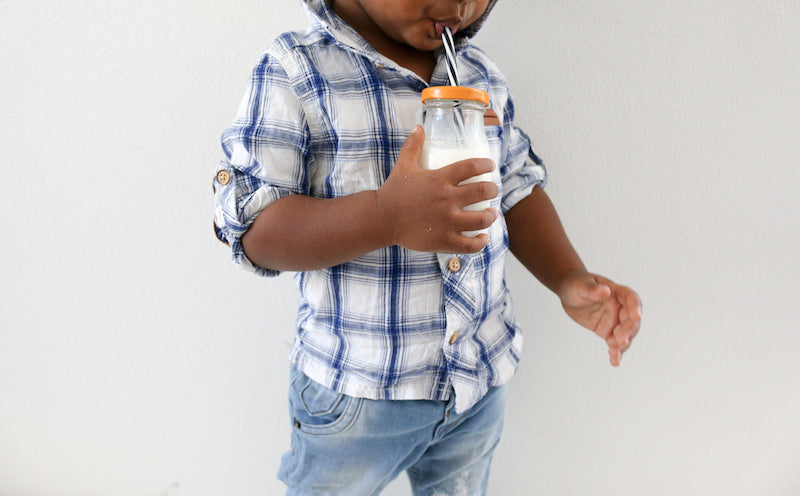 Toddler drinking milk from bottle