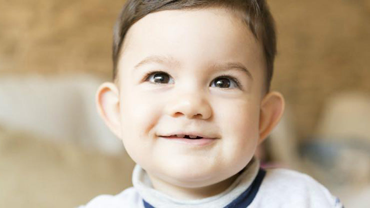 Sweet, smiling brown-eyed toddler