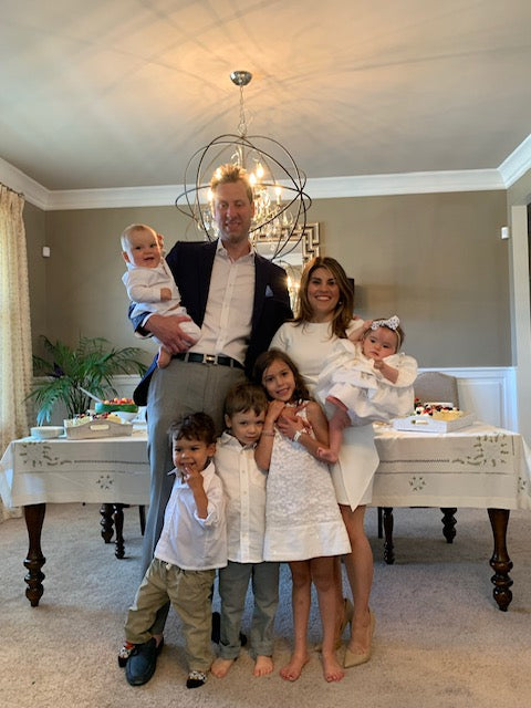 Happy family of 7 standing together in their dining room