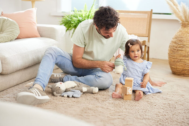 Dad and daughter playing with blocks on the floor