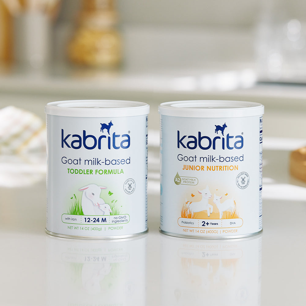 Tins of Kabrita Goat Milk Junior Nutrition and Kabrita Goat Milk Toddler Formula on a sunny kitchen counter